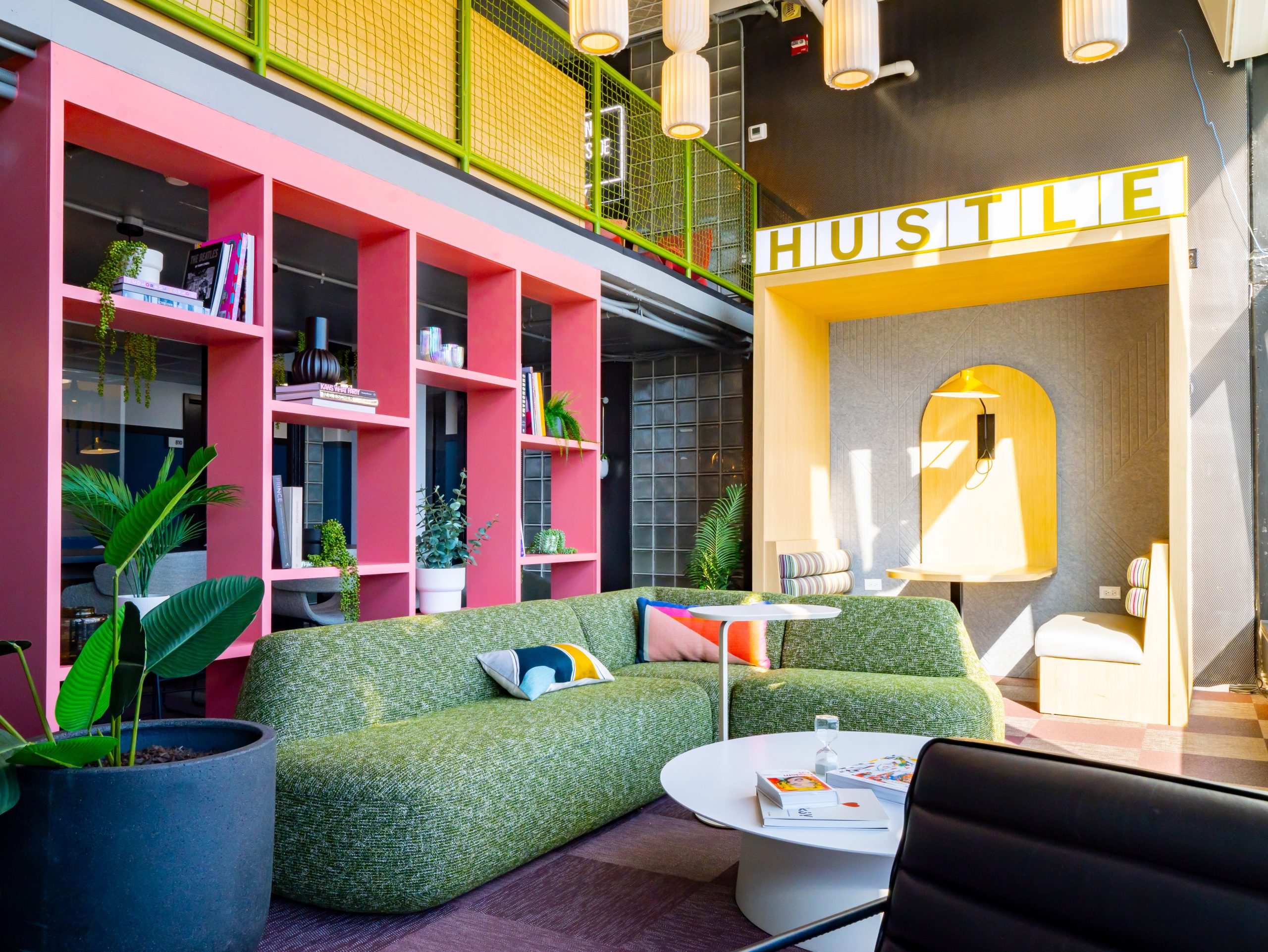colorful, vibrant lounge with green couch and yellow booth.